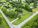 Aerial view of home and neighborhood showcasing mature trees and grassy yards at 615 Coan Dr, Locust Grove, GA 30248