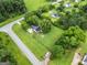 Aerial view of home and property surrounded by mature trees and grassy areas at 615 Coan Dr, Locust Grove, GA 30248