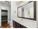 Well-lit bathroom features a large mirror over the vanity and an open walk-in closet at 615 Coan Dr, Locust Grove, GA 30248