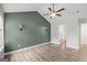 Spacious bedroom with high ceilings, ceiling fan, two sconces, and neutral paint at 615 Coan Dr, Locust Grove, GA 30248