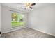 Bedroom features a large window, neutral paint, and plush carpet at 615 Coan Dr, Locust Grove, GA 30248