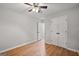 Bedroom features hardwood floors, a ceiling fan, and closet storage at 615 Coan Dr, Locust Grove, GA 30248