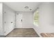 Entryway with laminate floors, white trim, and large storage closet at 615 Coan Dr, Locust Grove, GA 30248