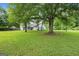 Home with mature trees and a large front yard at 615 Coan Dr, Locust Grove, GA 30248