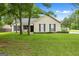 Charming single-story home with a well-manicured lawn and mature trees enhancing its curb appeal at 615 Coan Dr, Locust Grove, GA 30248