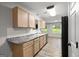 Bright kitchen featuring shaker cabinets, stainless steel appliances and laminate floors throughout at 615 Coan Dr, Locust Grove, GA 30248