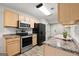 Functional kitchen featuring stainless steel appliances, light wood cabinets and laminate countertops at 615 Coan Dr, Locust Grove, GA 30248