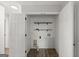 Laundry room featuring a folding table, overhead shelving, and laminate floors at 615 Coan Dr, Locust Grove, GA 30248