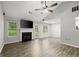 Spacious living room boasts hardwood floors, fireplace, modern ceiling fan, and backyard access at 615 Coan Dr, Locust Grove, GA 30248