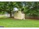 Backyard storage shed offers extra space and sits within fenced area at 615 Coan Dr, Locust Grove, GA 30248