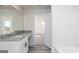 Bathroom featuring granite countertop vanity and modern fixtures, and an open doorway to a bedroom at 493 Prescott Way, Villa Rica, GA 30180