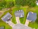 Aerial view of three houses in a cul-de-sac, surrounded by green trees and lawns at 102 Natalie Ct, Dallas, GA 30157