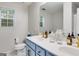 Stylish bathroom with double sinks, bright light, and modern gold fixtures at 102 Natalie Ct, Dallas, GA 30157
