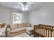 Cozy Bedroom with a crib, sofa, and natural light from the window at 102 Natalie Ct, Dallas, GA 30157