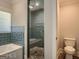 Modern bathroom with stone-tile shower, new toilet, and natural light at 2739 Flagstone Se Dr, Atlanta, GA 30316