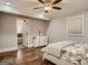 Comfortable bedroom with a ceiling fan, hardwood floors, and a view to a bathroom at 2739 Flagstone Se Dr, Atlanta, GA 30316