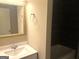 Modern bathroom features vanity sink with gold-trimmed mirror and tiled backsplash at 6300 Creekford Ln, Lithonia, GA 30058