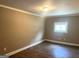 Cozy bedroom with new flooring, soft lighting, and a window bringing in natural light at 6300 Creekford Ln, Lithonia, GA 30058