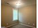Neutral bedroom showcases a window that offers natural light with neutral walls and carpeted floor at 6300 Creekford Ln, Lithonia, GA 30058