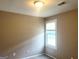 Neutral bedroom showcases a window that offers natural light with neutral walls and carpeted floor at 6300 Creekford Ln, Lithonia, GA 30058