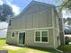 Backyard exterior featuring neutral colors, multiple windows, and a sliding glass door at 6300 Creekford Ln, Lithonia, GA 30058