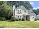 Classic two-story home with a lovely lawn and mature trees offering curb appeal and charm at 6300 Creekford Ln, Lithonia, GA 30058