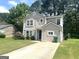 Inviting two-story home with a well-maintained lawn, neutral paint, and a convenient driveway at 6300 Creekford Ln, Lithonia, GA 30058