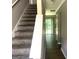 Inviting hallway with a staircase leading to the upper level and a view of the backyard at 6300 Creekford Ln, Lithonia, GA 30058