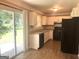 Bright kitchen featuring modern appliances, white cabinets, and a sliding glass door to the outside at 6300 Creekford Ln, Lithonia, GA 30058