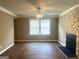 Bright living room with modern flooring, a stylish fireplace, and a large window at 6300 Creekford Ln, Lithonia, GA 30058