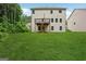 A large lawn and the rear facade of the home with a deck at 5662 Valley Loop, Fairburn, GA 30213