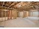 Unfinished basement with exposed ceiling, and natural light, ready to be customized at 5662 Valley Loop, Fairburn, GA 30213