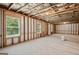 Unfinished basement with exposed beams, windows, and natural light at 5662 Valley Loop, Fairburn, GA 30213