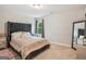 Cozy bedroom with a queen size bed and window views and a decorative mirror at 5662 Valley Loop, Fairburn, GA 30213