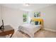 Cozy bedroom features a yellow headboard, decorative pillows, and a bright window at 5662 Valley Loop, Fairburn, GA 30213