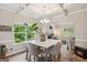 Elegant dining area with hardwood floors, tray ceiling, and modern chandelier offers a refined ambiance at 5662 Valley Loop, Fairburn, GA 30213
