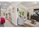 Open-concept living area featuring hardwood floors, neutral paint, arched doorways, and lots of natural light at 5662 Valley Loop, Fairburn, GA 30213