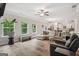 Spacious living room featuring lots of natural light, wood floors, and neutral decor, offering a calming living space at 5662 Valley Loop, Fairburn, GA 30213