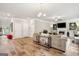 Bright and open living area with a fireplace, neutral-toned furniture, and wood flooring, ideal for relaxation and gatherings at 5662 Valley Loop, Fairburn, GA 30213