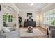 Bright living room with hardwood floors, neutral paint, arched doorways, modern decor, and lots of natural light at 5662 Valley Loop, Fairburn, GA 30213