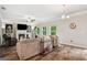 Comfortable living room with a fireplace, large windows, and cozy seating, creating a relaxing and inviting atmosphere at 5662 Valley Loop, Fairburn, GA 30213