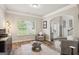 Bright living room featuring hardwood floors, neutral paint, modern decor, arched doorways, and lots of natural light at 5662 Valley Loop, Fairburn, GA 30213