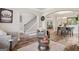 Open-concept living area with hardwood floors, neutral paint, arched doorways, stairs, and lots of natural light at 5662 Valley Loop, Fairburn, GA 30213