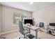 Well-lit home office featuring a sit stand desk and ergonomic chair, perfect for remote work at 5662 Valley Loop, Fairburn, GA 30213