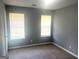 Comfortable bedroom with two windows for natural light and neutral carpeting at 6650 Smoke Ridge, Atlanta, GA 30349
