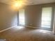 Spacious bedroom with neutral walls, carpet, and ceiling fan with natural light from large windows at 6650 Smoke Ridge, Atlanta, GA 30349