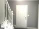 Bright entryway with white staircase and door, offering a clean and inviting first impression at 6650 Smoke Ridge, Atlanta, GA 30349