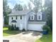 Charming two-story home with a well-maintained lawn and attached two-car garage, offering curb appeal at 6650 Smoke Ridge, Atlanta, GA 30349