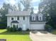 Charming two-story home with a well-maintained lawn and attached two-car garage, offering curb appeal at 6650 Smoke Ridge, Atlanta, GA 30349