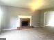 Cozy living room with a classic brick fireplace and neutral carpeting at 6650 Smoke Ridge, Atlanta, GA 30349